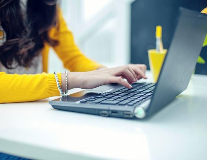 Woman browsing social network on laptop