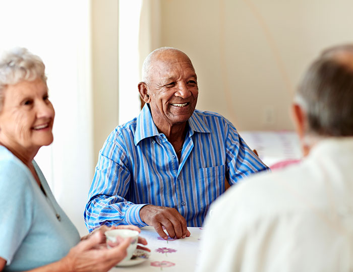 Older man having coffee with friends