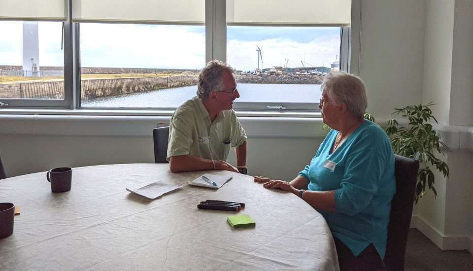 Image of workshop participants in conversation.