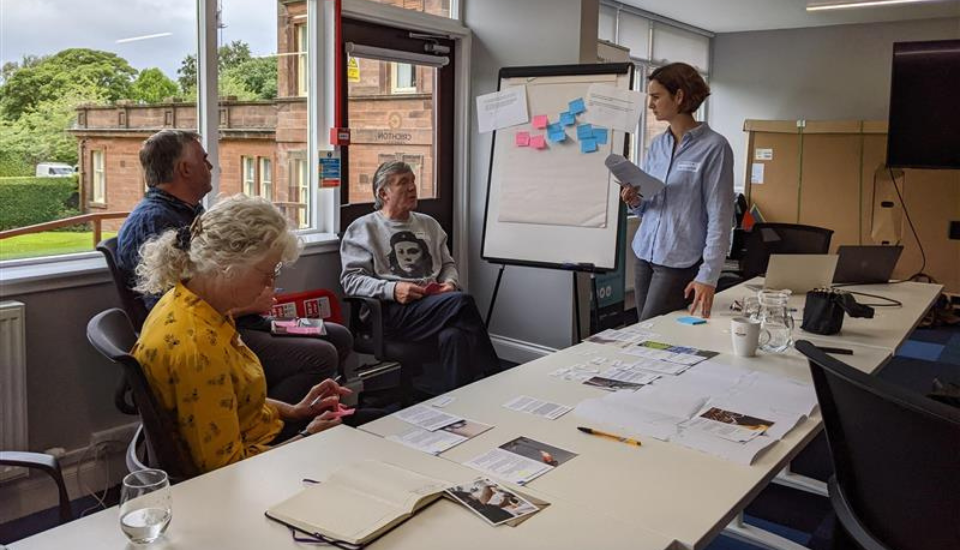 Image of participants discussing driver cards with a facilitator.