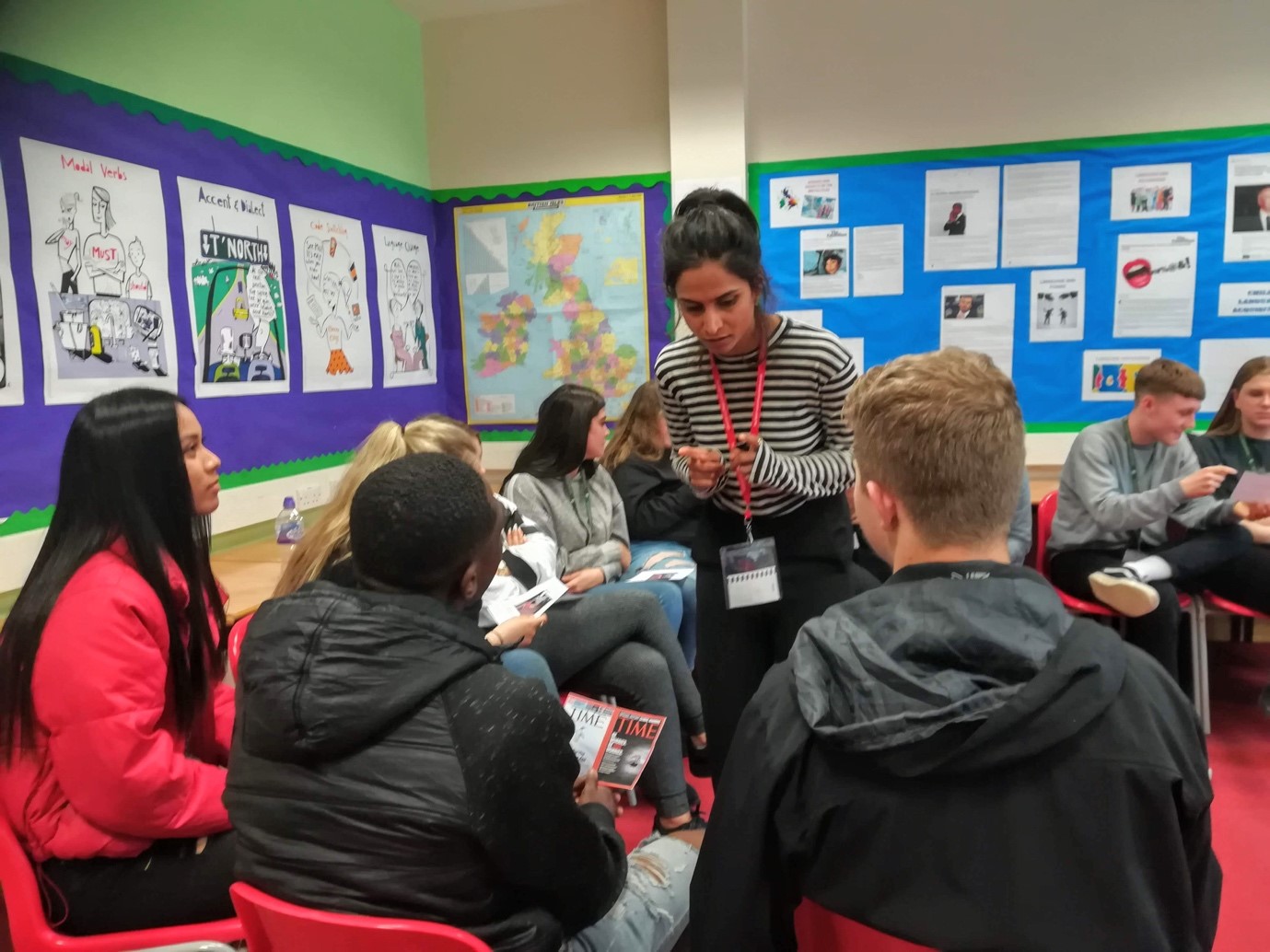 Photo of Shadow heroes workshop facilitator speaking with students in classroom